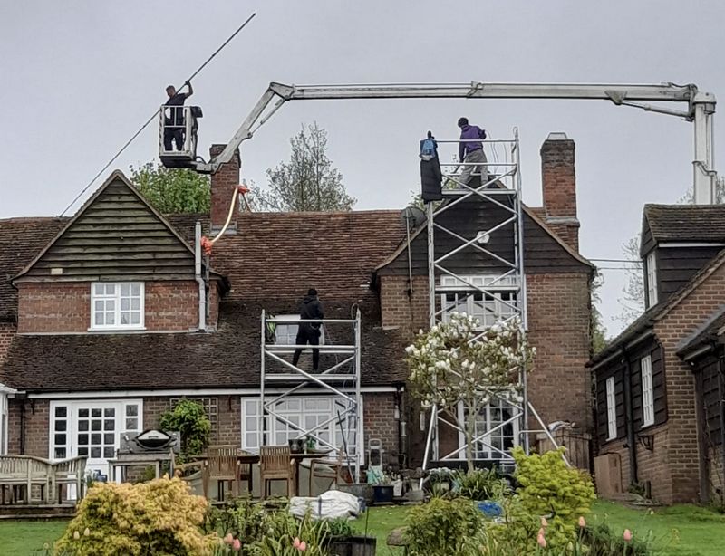 The Moss Cleaners using cherry picker and scaffolding to clean roof safely and professionally in Thornbury, Gloucestershire